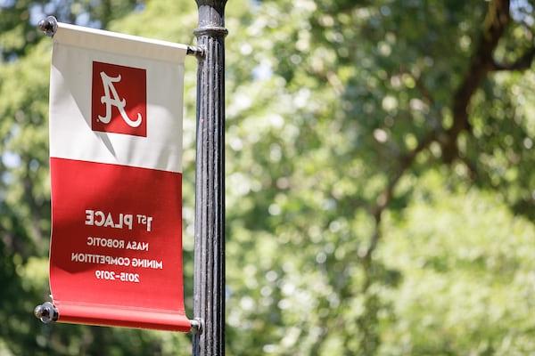 A banner celebrating macaugalaxy银河国际's 1st place finish in NASA's robotics competition hangs on a light post